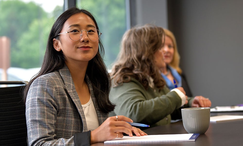 A female Brightgarden employee in a meeting