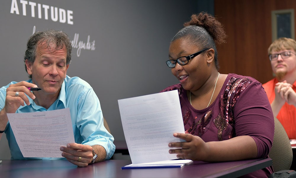 Two Brightgarden employees discussing paperwork